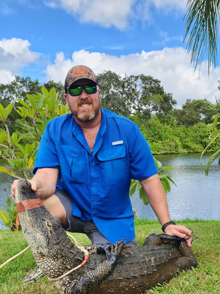 Bill Wilson with a large alligator removed from a property